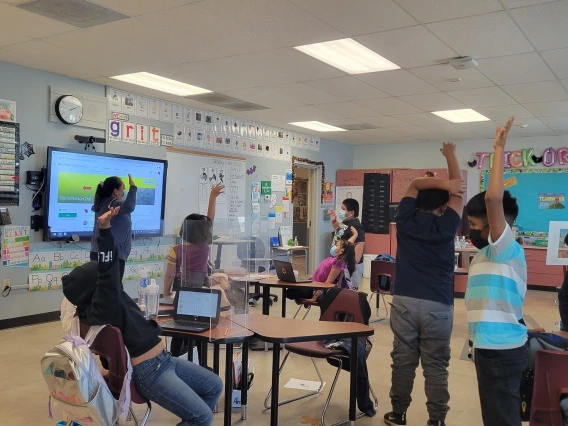 students raising their hands