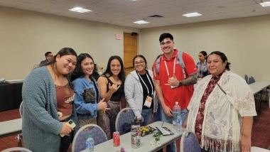 students smiling in a classroom - group pic